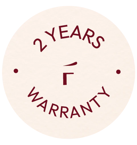 Circular badge with the text "2 YEARS WARRANTY" in dark red, surrounding a central symbol and two dots on either side.